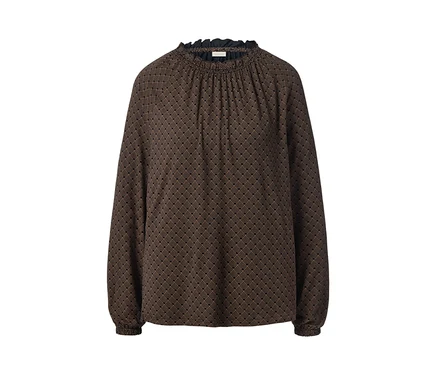 Blouse imprimée noire sur fond blanc.