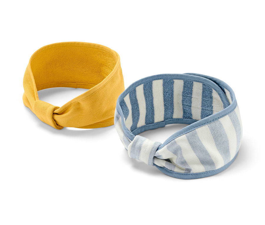 Deux bandeaux cosmétiques : un jaune uni et un blanc-bleu à rayures.