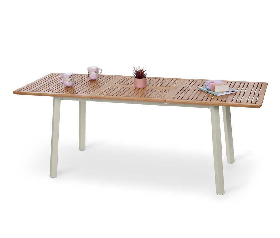 Table à rallonge « Liska » avec deux tasses, une petite plante en pot et des livres.