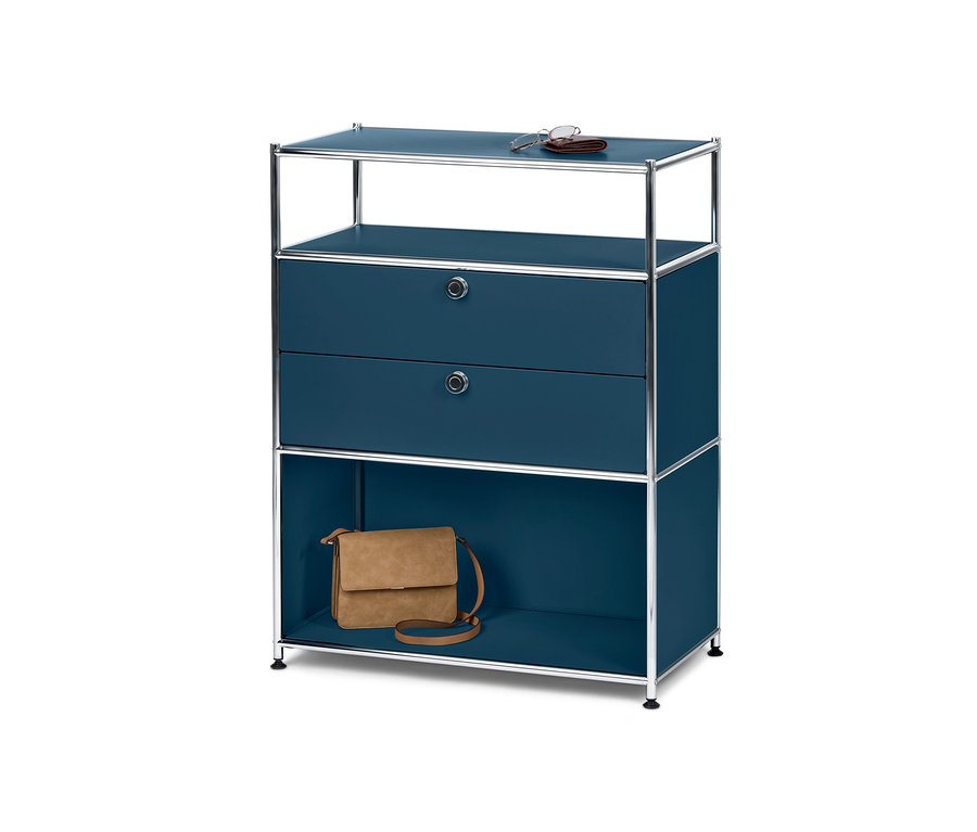 Une commode bleue « CN3 » avec 2 tiroirs. Sur l'étagère supérieure se trouvent des lunettes et un portefeuille, et sur l'étagère inférieure un sac à main marron.