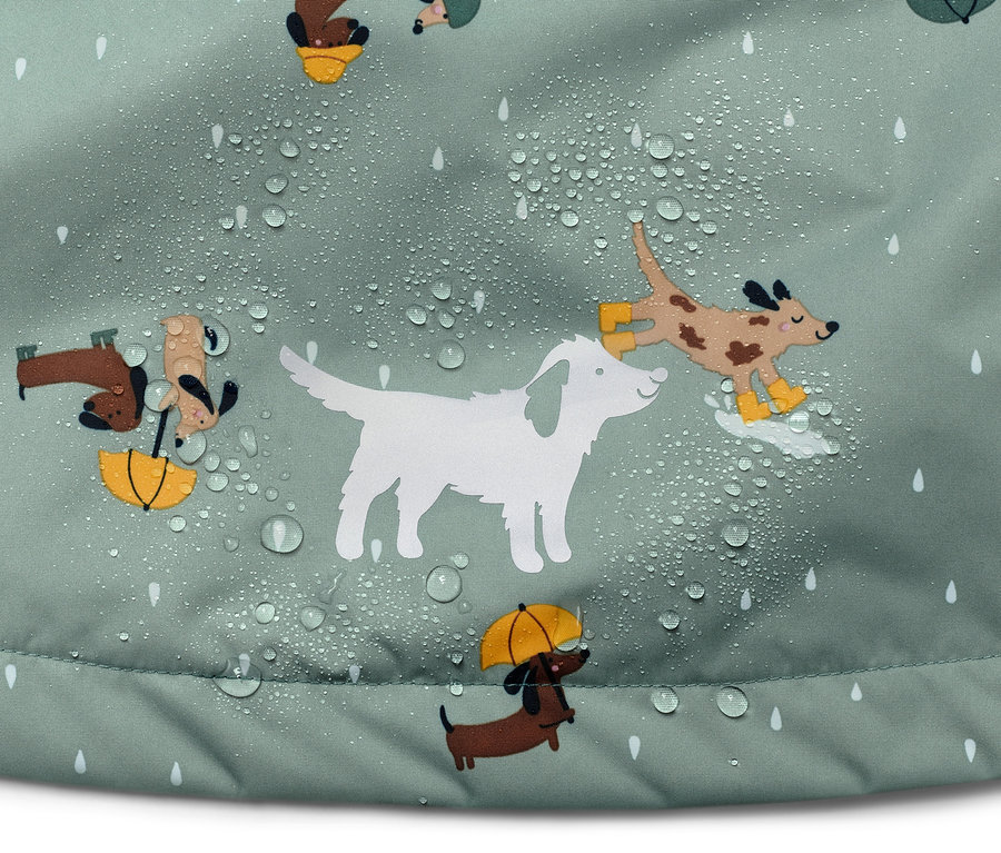 Détail d'une veste de pluie thermique pour enfant avec motif de chiens et de gouttes de pluie.