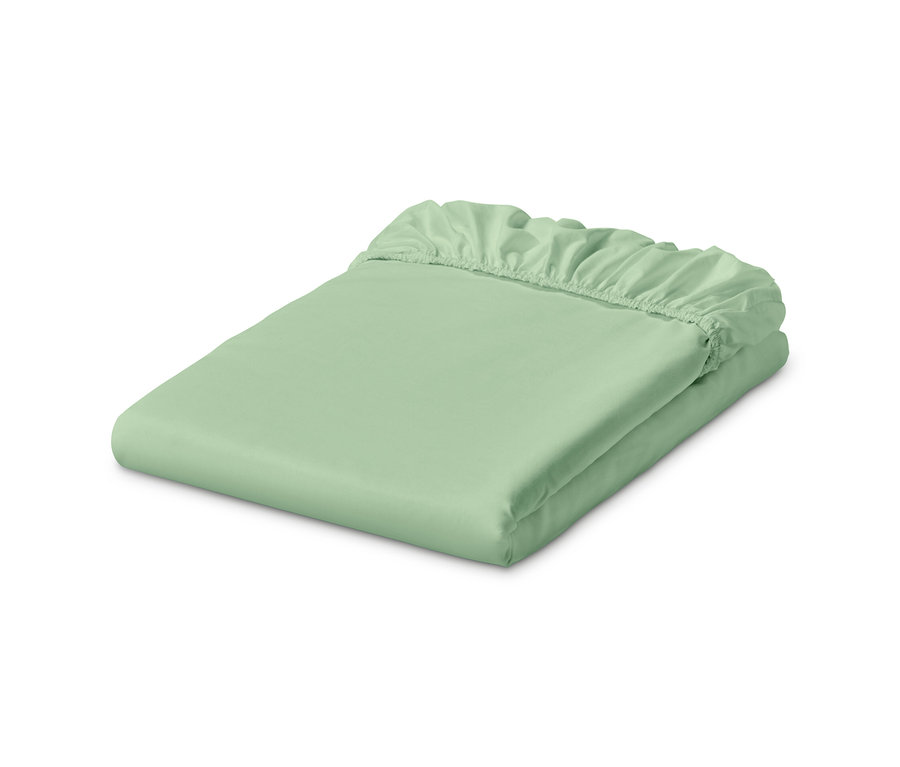 Un drap-housse en jersey vert clair est plié.