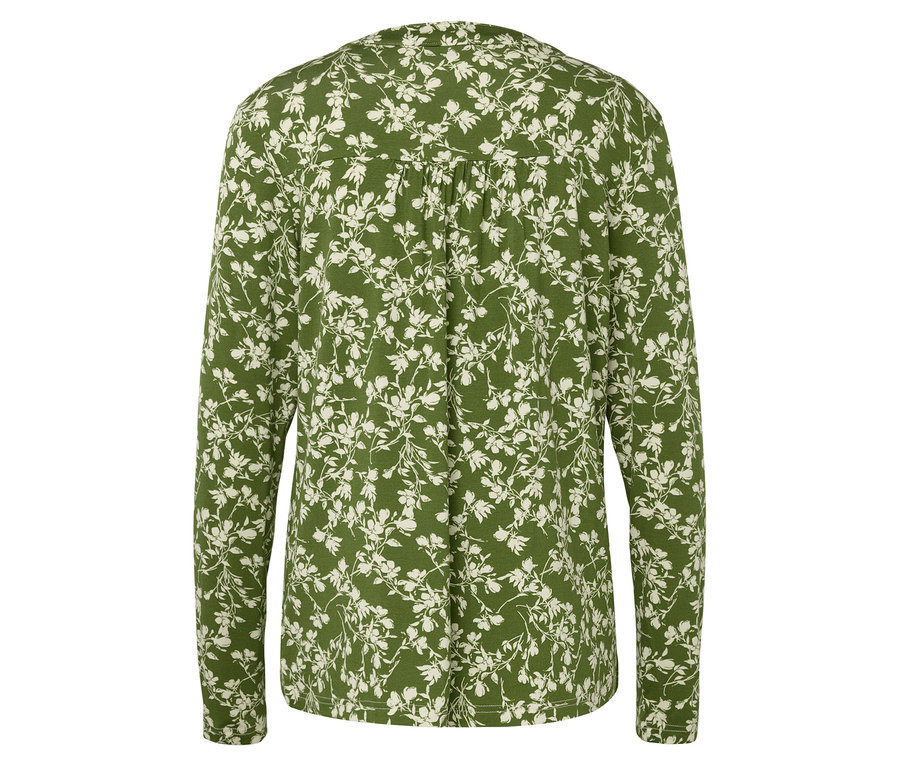 Vue arrière d'un chemisier vert à manches longues avec un motif floral blanc.