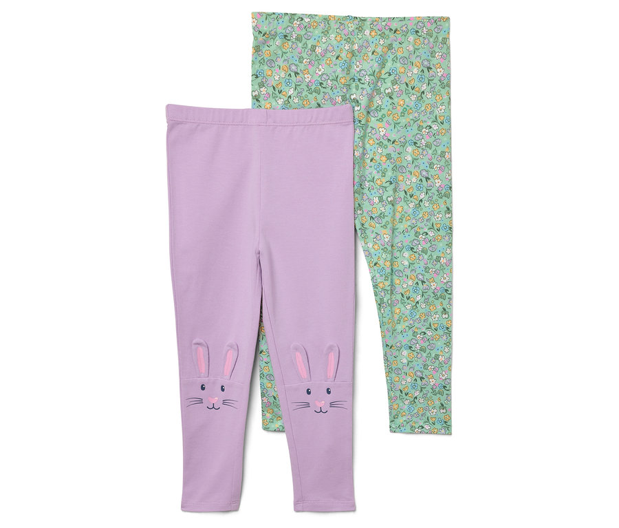 Deux leggings. Un legging violet avec des oreilles et un visage de lapin sur les genoux et un legging vert à motif floral.