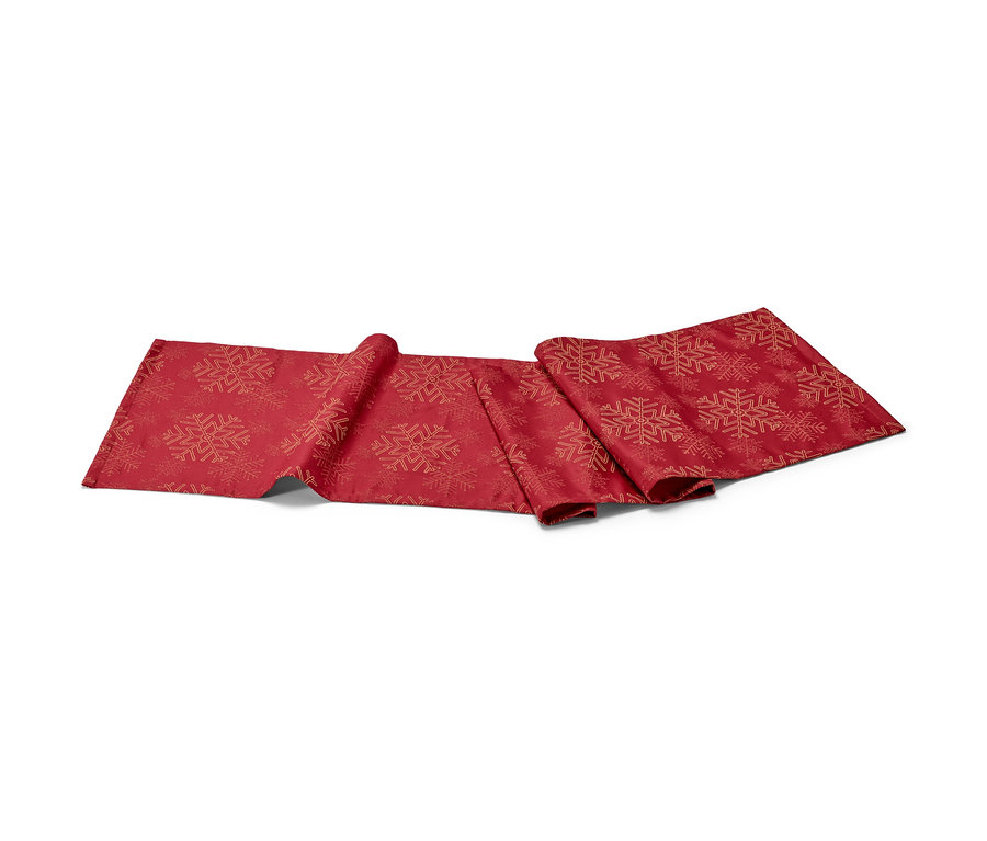 Chemin de table en jacquard rouge avec motif de flocons de neige.
