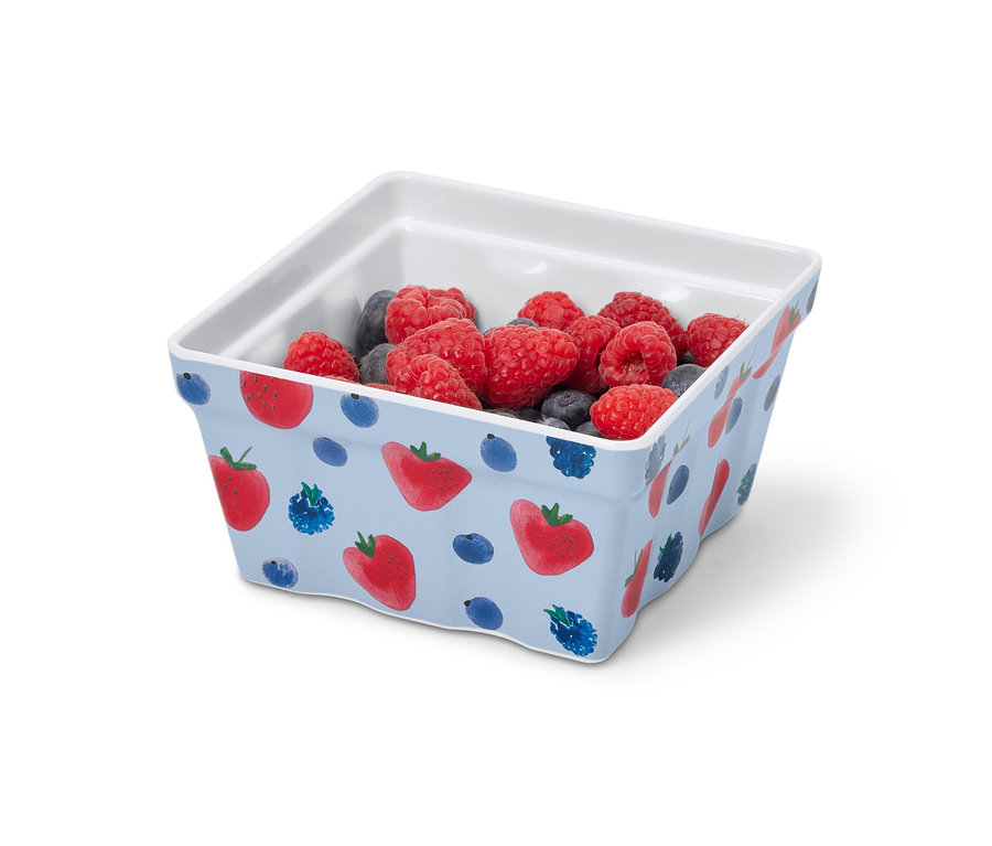 Un bac à fraises rempli de framboises et de myrtilles.