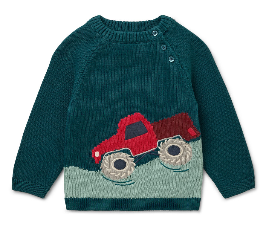 Pull vert avec un camion rouge.
