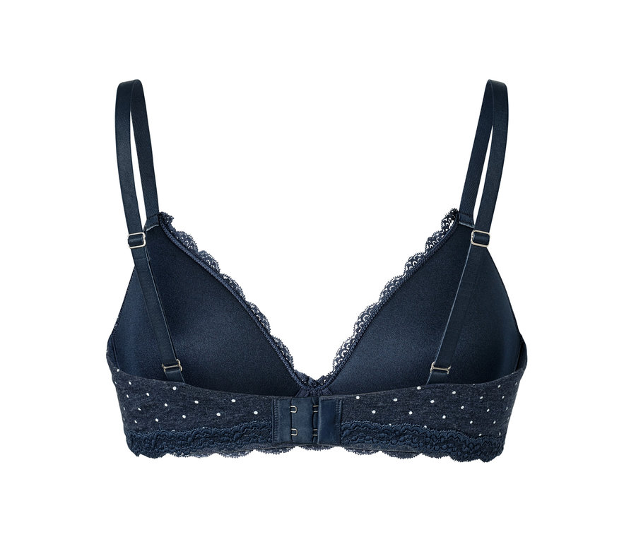 Vue détaillée de l'arrière d'un soutien-gorge à coques souples bleu foncé avec des pois blancs.