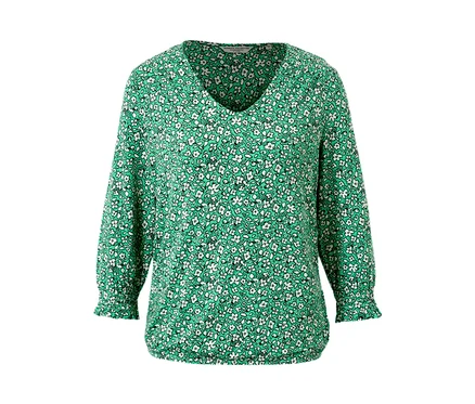 Blouse imprimée verte à manches longues.