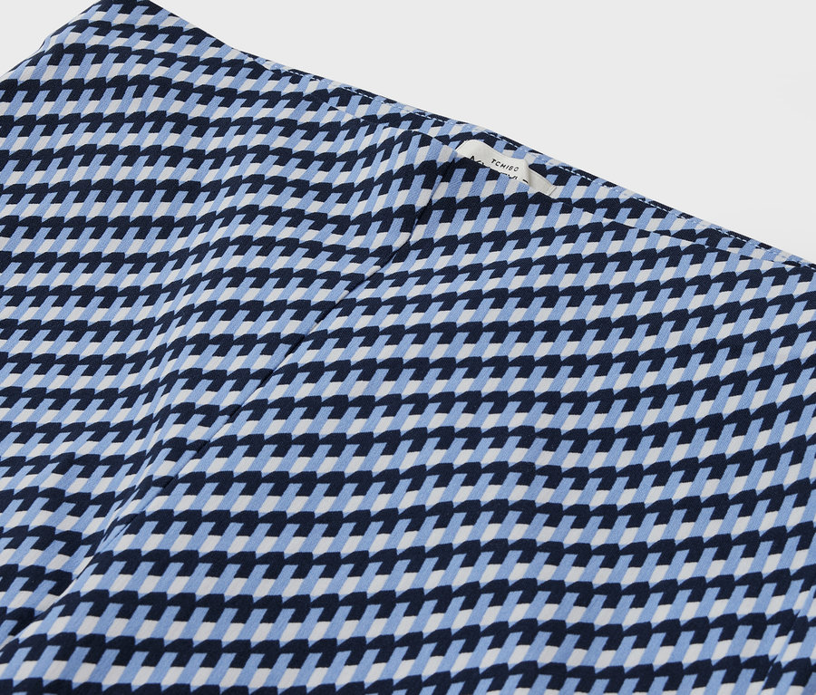 Gros plan d'un tissu à motifs avec un design géométrique en bleu et blanc.