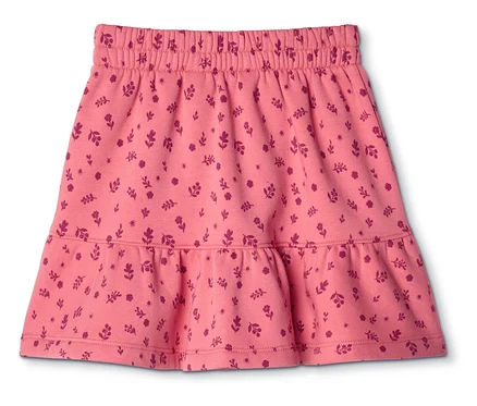 Jupe rose à taille élastique et à volant sur l'ourlet, recouverte d'un motif de fleurs et de feuilles rose foncé.