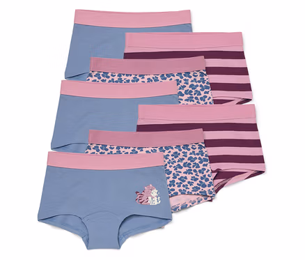 Six culottes de fille de différents motifs et couleurs sont superposées. L'une est bleue avec un motif de chat.