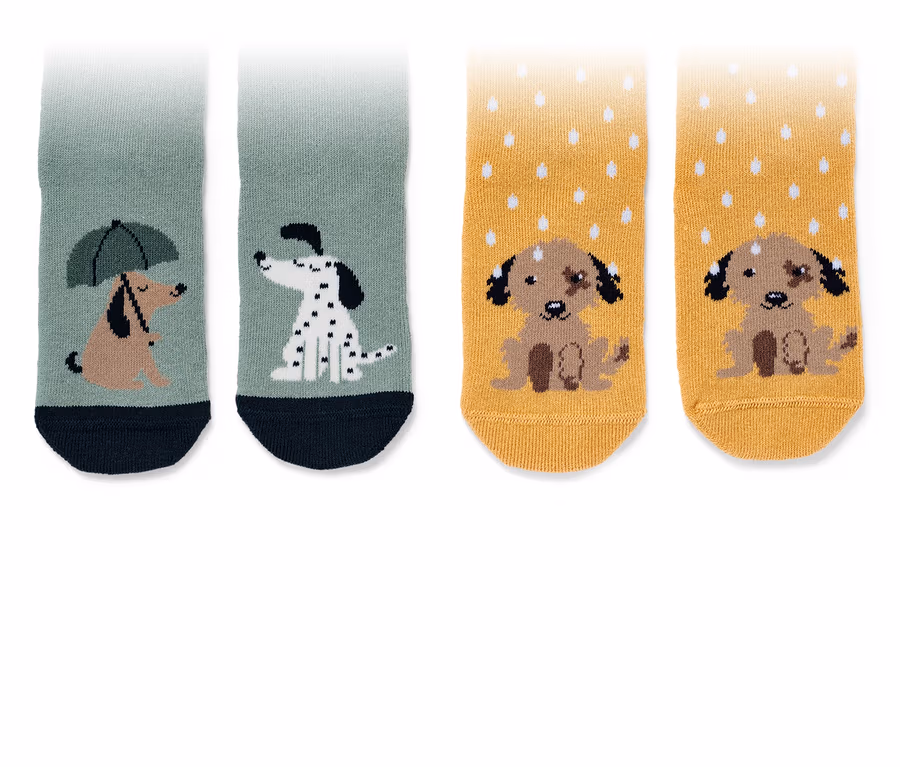 Deux paires de chaussettes anti-dérapantes pour enfant avec motifs de chiens.