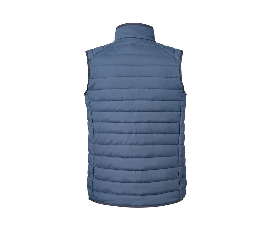 Détail d'un gilet matelassé réversible bleu.