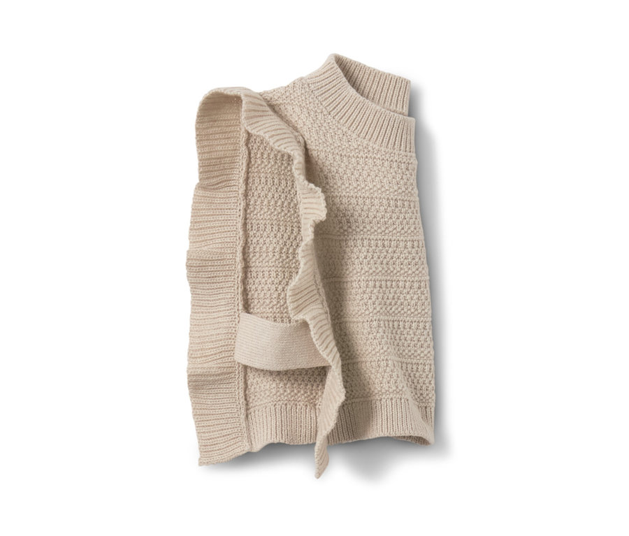Pull sans manches en maille beige pour enfant avec des volants d'un côté.