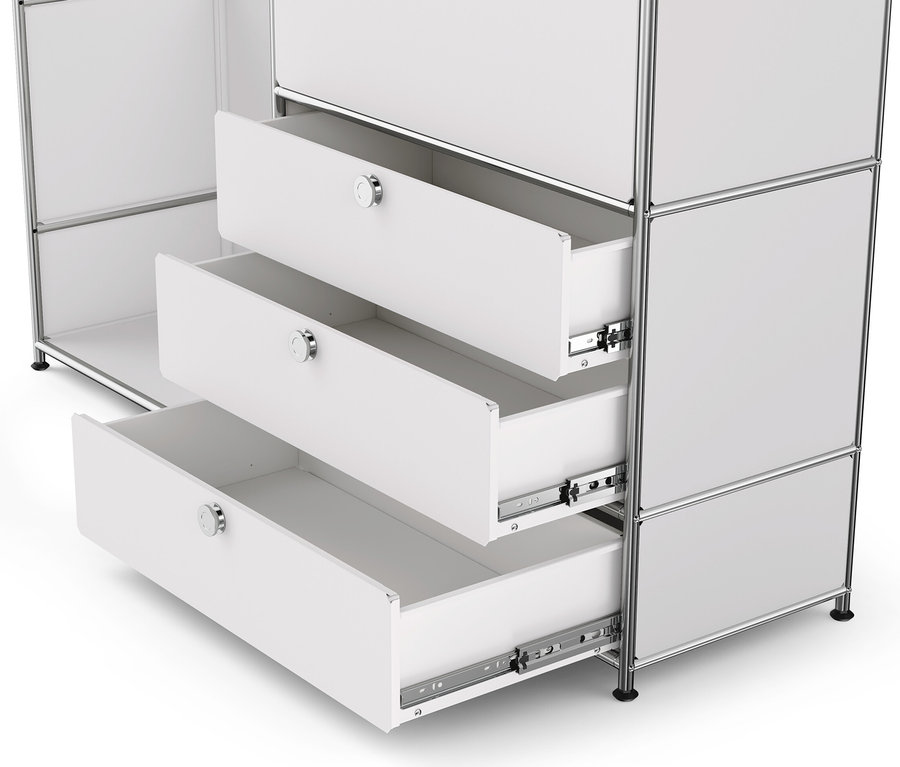 Gros plan d'une commode en métal blanche « CN3 » avec plateau en bois, 1 tringle à vêtements, 1 abattant et 3 tiroirs, dont 3 sont ouverts.