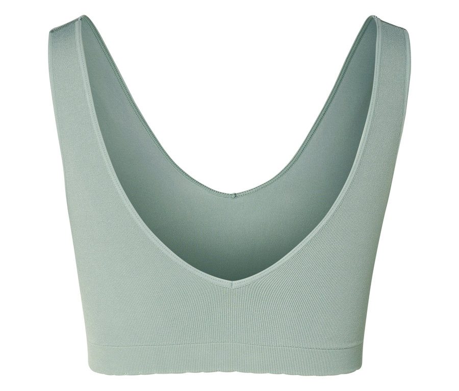 Gros plan d'un soutien-gorge de sport vert clair avec un col en V.