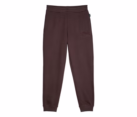 Pantalon de jogging marron foncé avec taille élastique et chevilles côtelées, orné d'un logo brodé « FILA ESTABLISHED 1911 » sur la cuisse gauche.