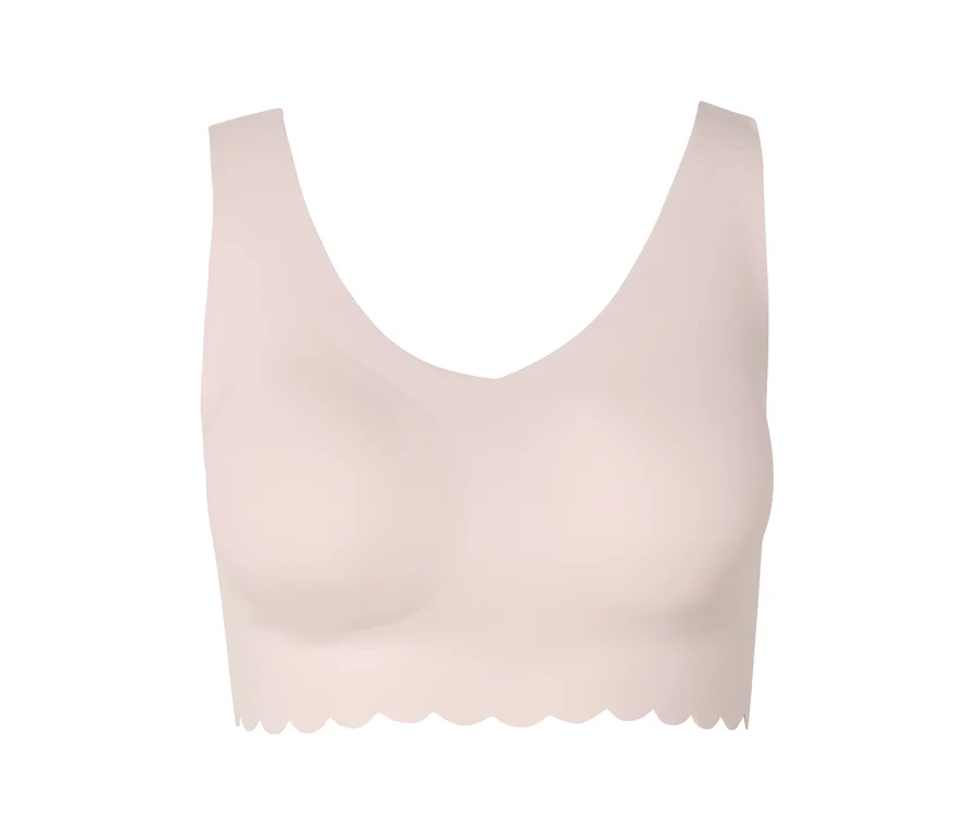 Soutien-gorge rose clair sans armatures avec ourlet ondulé.