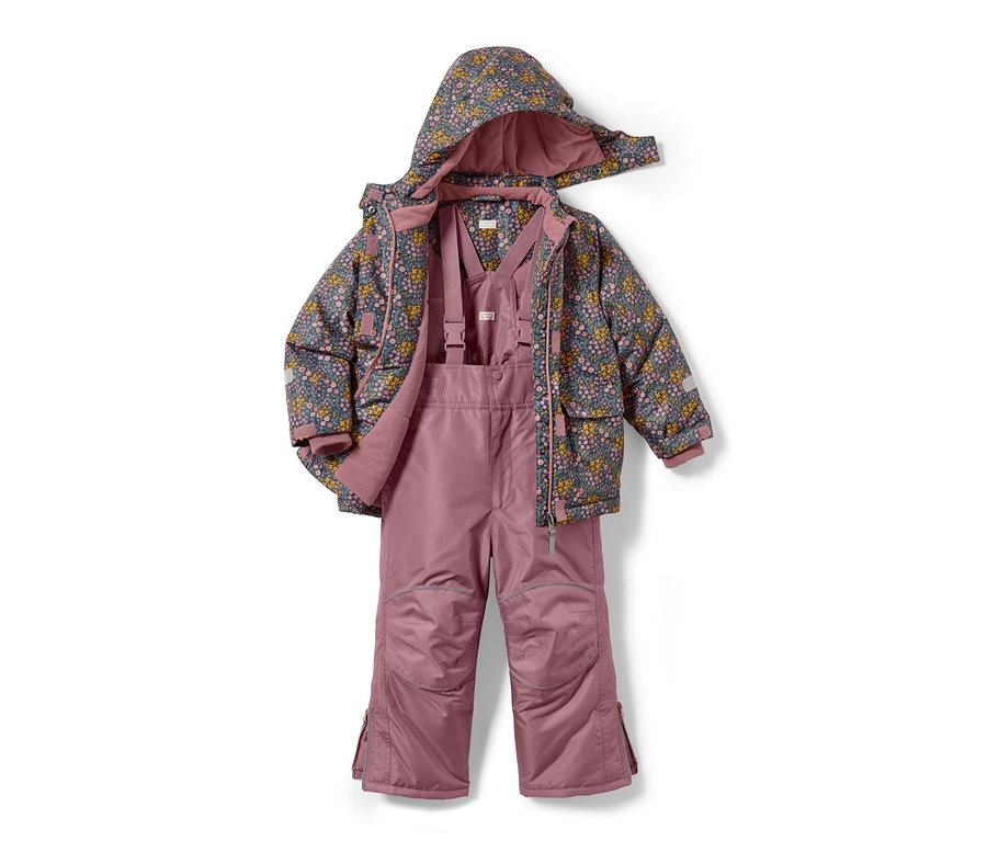 Combinaison de ski 2 pièces rose avec motif floral sur la veste.