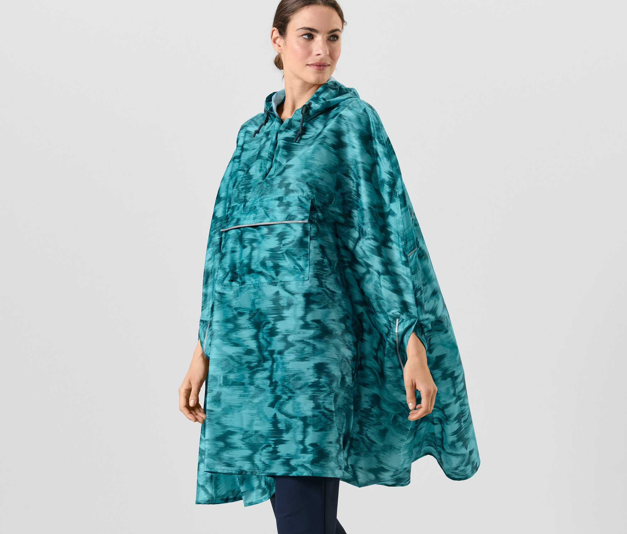 Femme portant un poncho de pluie avec imprimé intégral.