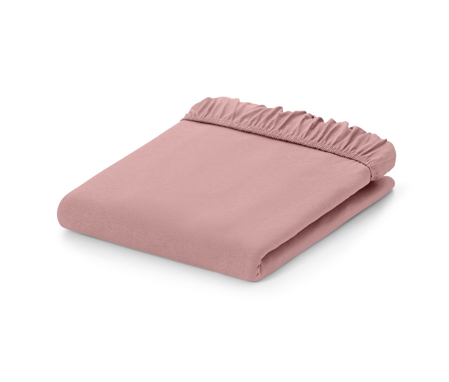Drap-housse en jersey rose plié.