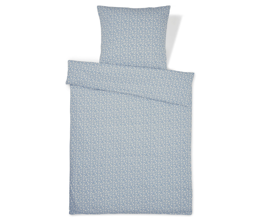 Parure de lit en jersey bleu à motifs, taille normale et grande taille, étalée à plat.