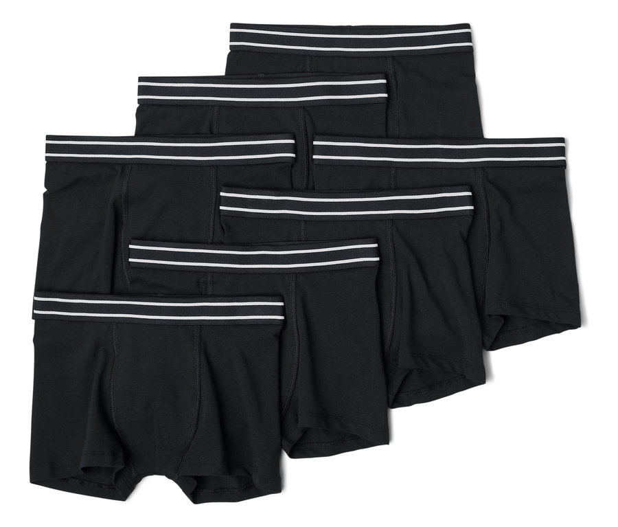 Pile de six boxers noirs avec des bandes blanches à la taille.