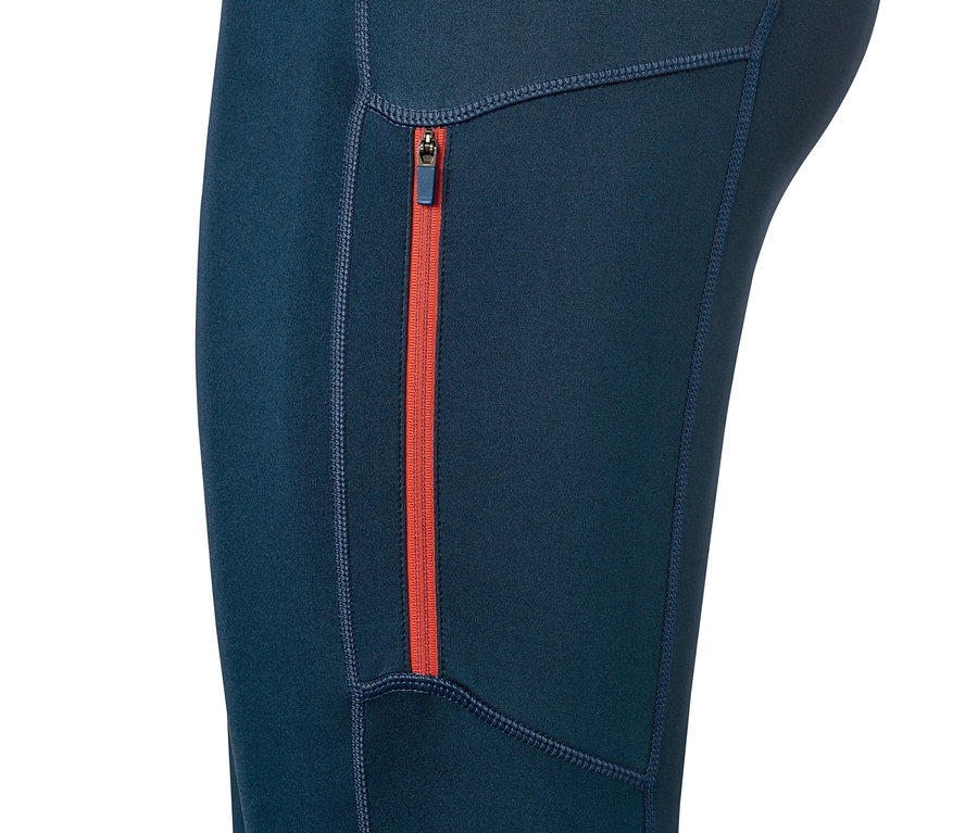 Détail d'un legging de sport avec une fermeture éclair orange.