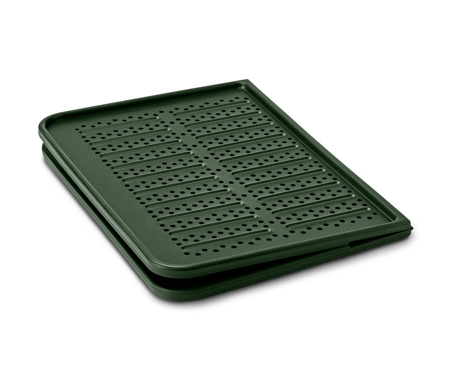 Une plaque de four en silicone verte avec une surface perforée.