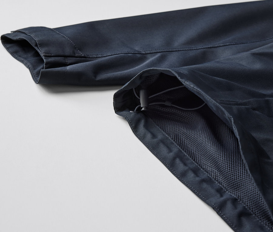 Gros plan sur un parka technique montrant la manche et une partie de la fermeture éclair.