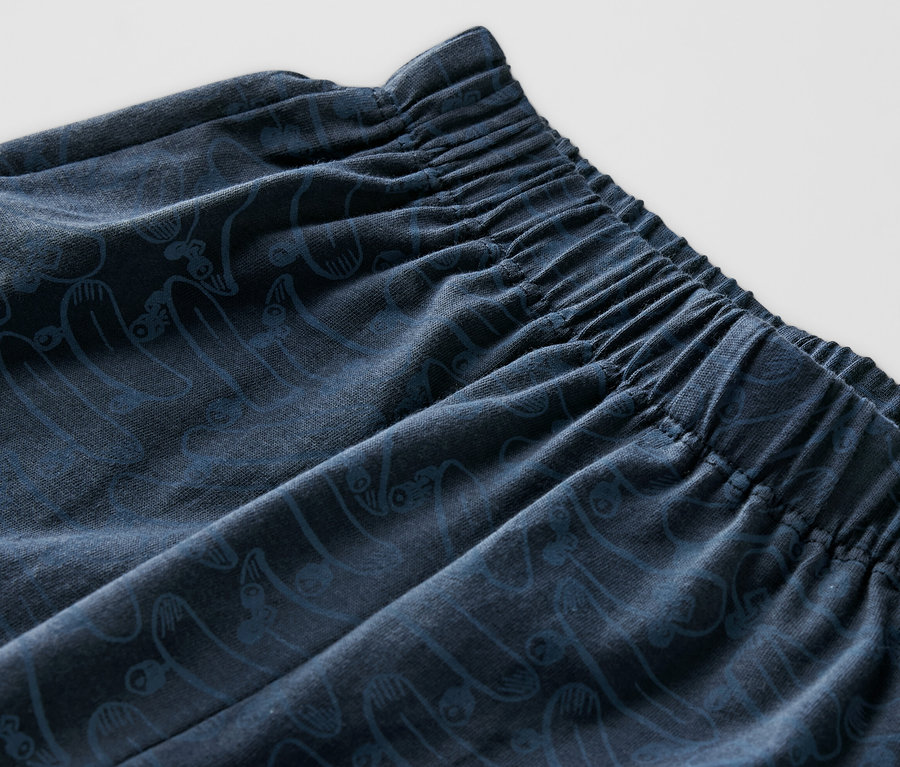 Détail d'un pyjama court pour enfant avec taille élastique et motif.