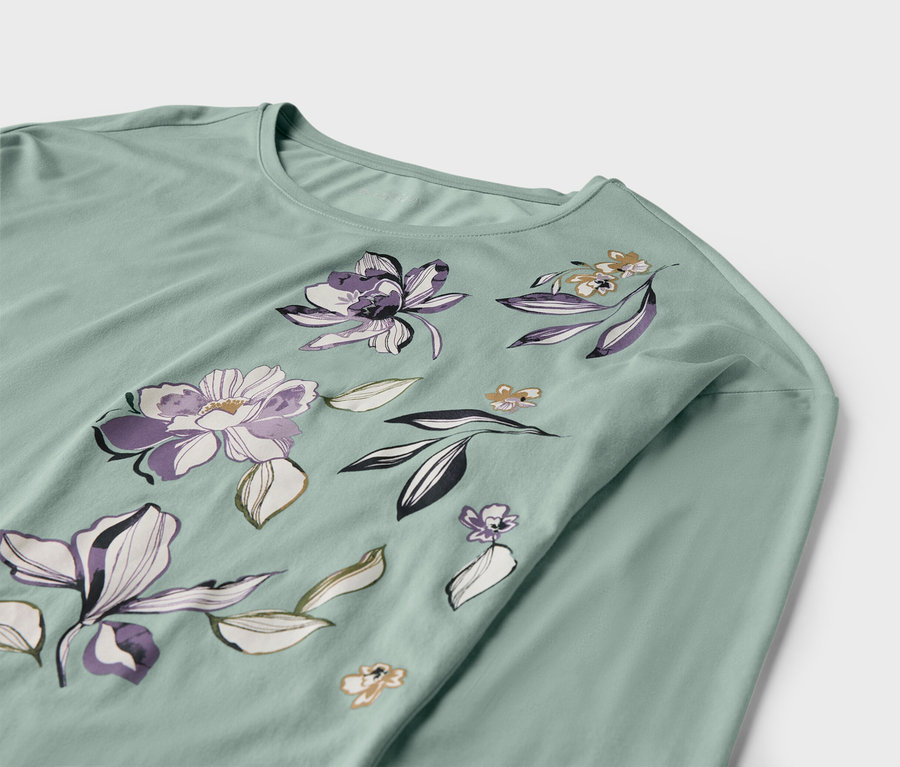 T-shirt vert clair à manches longues avec motif floral.