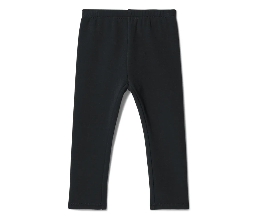 Legging noir avec taille élastique, posé à plat.