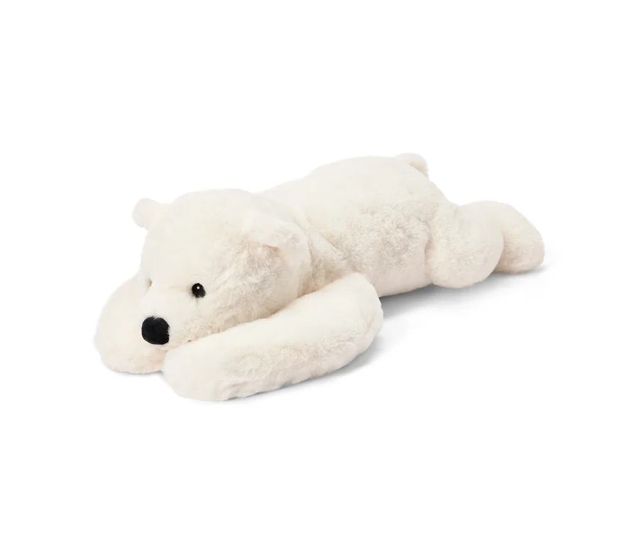 Peluche blanche et moelleuse en forme d'ours polaire, allongée sur le ventre, avec des yeux et un nez noirs.