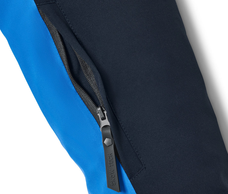 Détail d'une veste de ski bleue avec fermeture éclair.