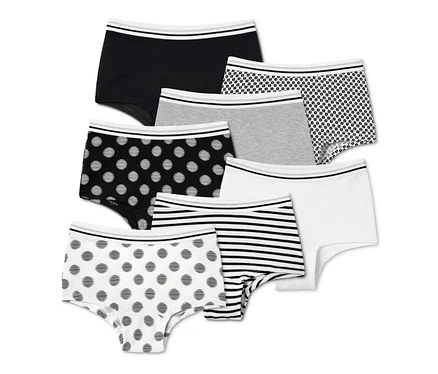 Sept culottes pour filles dans différents motifs, noir, blanc, gris et imprimé.