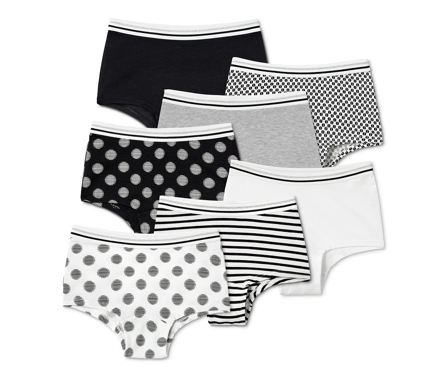 Sept culottes pour filles dans différents motifs, noir, blanc, gris et imprimé.