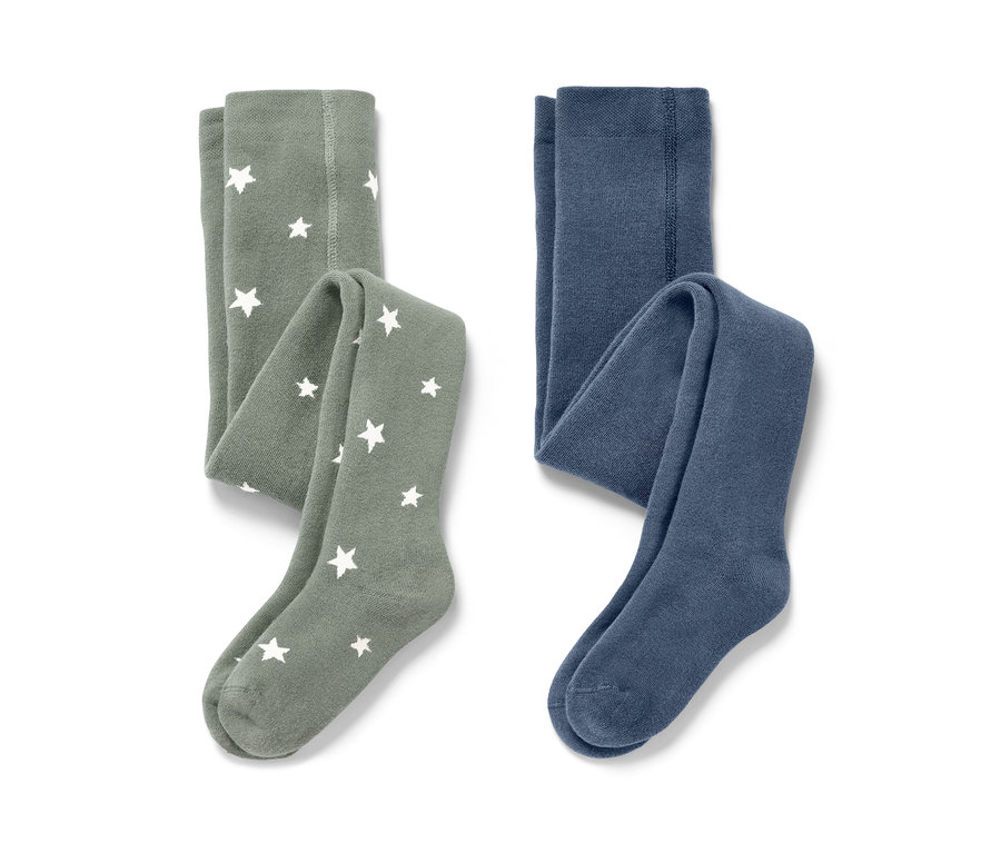 Deux collants thermiques pour enfant, bleu et vert. Un vert avec des étoiles blanches.