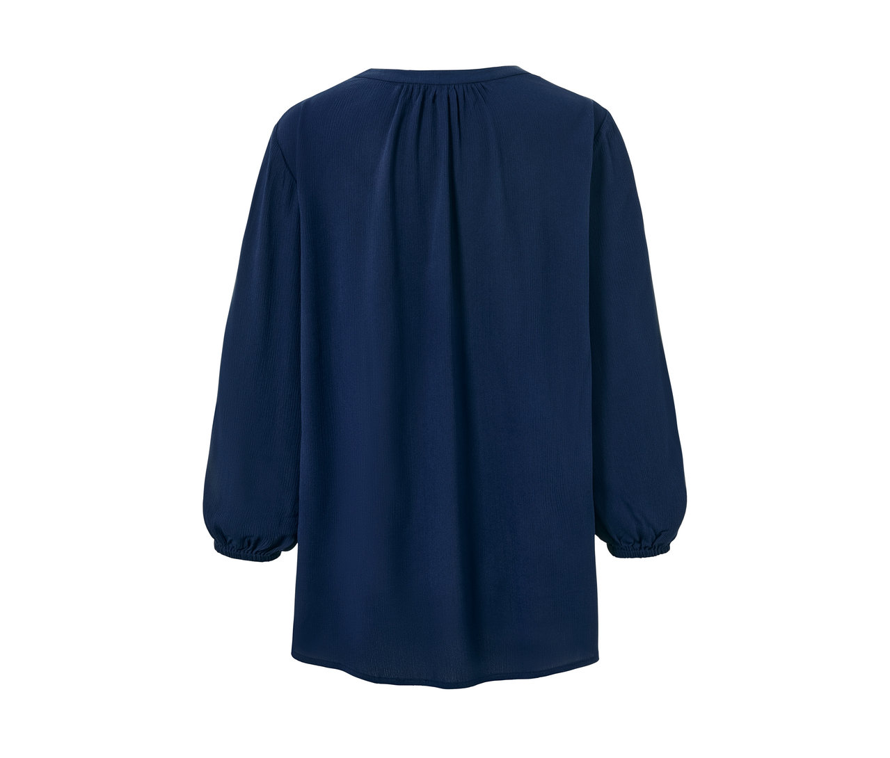 Un chemisier-tunique bleu à manches longues.