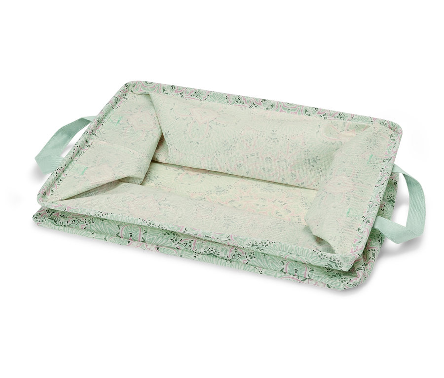 Une boîte de rangement pliable vert clair avec un motif floral et des poignées vert clair.