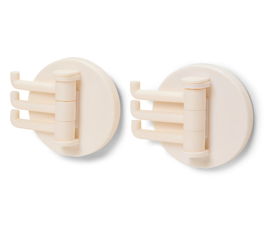 Deux crochets rotatifs crème sur fond blanc.