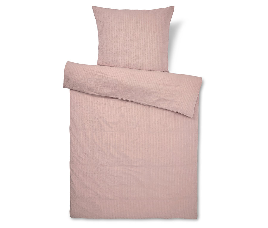 Literie rose rayée, incluant une taie d'oreiller.