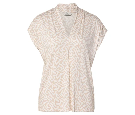 Un chemisier à manches courtes beige et blanc à motif avec un col en V.