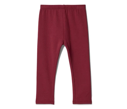 Legging enfant rouge foncé, posé à plat sur un fond blanc.