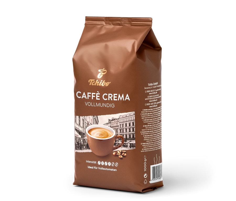 Sachet marron de café en grains Tchibo Caffè Crema Vollmundig (1 kg) avec une tasse de café et des grains de café.