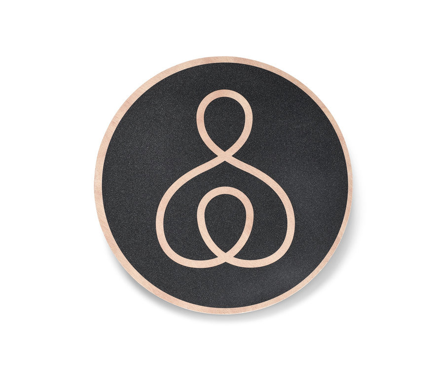 Un plateau d’équilibre rond avec une surface noire et un bord beige.