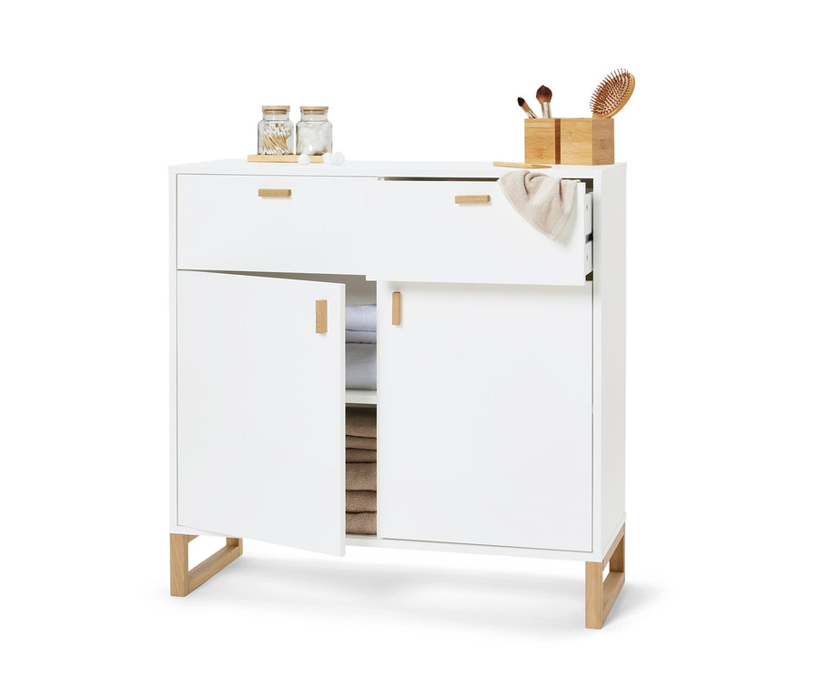 Meuble de rangement blanc avec 2 tiroirs et 2 portes, une porte est ouverte et l'intérieur est rempli de serviettes.
