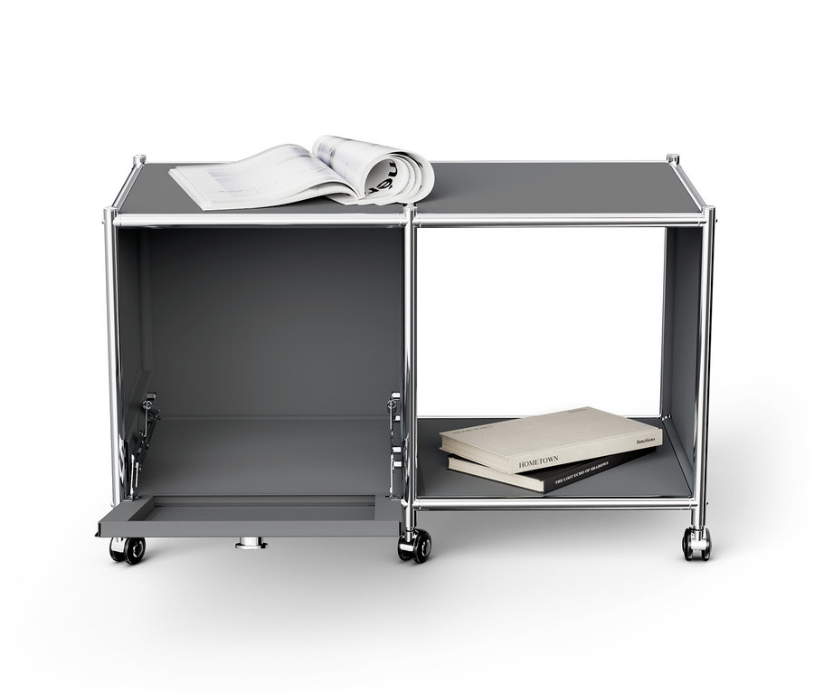 Table d’appoint métallique grise « CN3 » avec un abattant ouvert, un livre et un magazine.