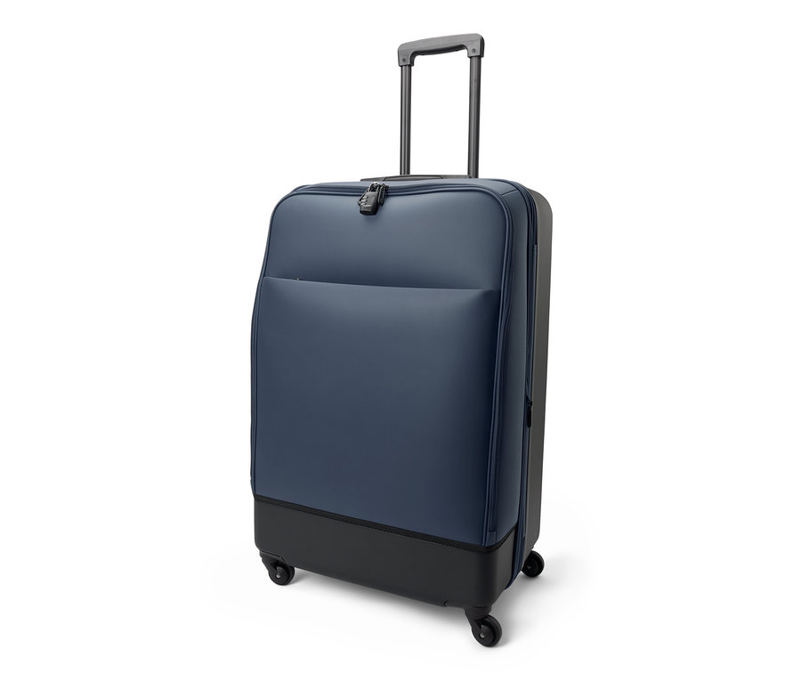 Une grande valise hybride bleue avec une poignée rétractable.